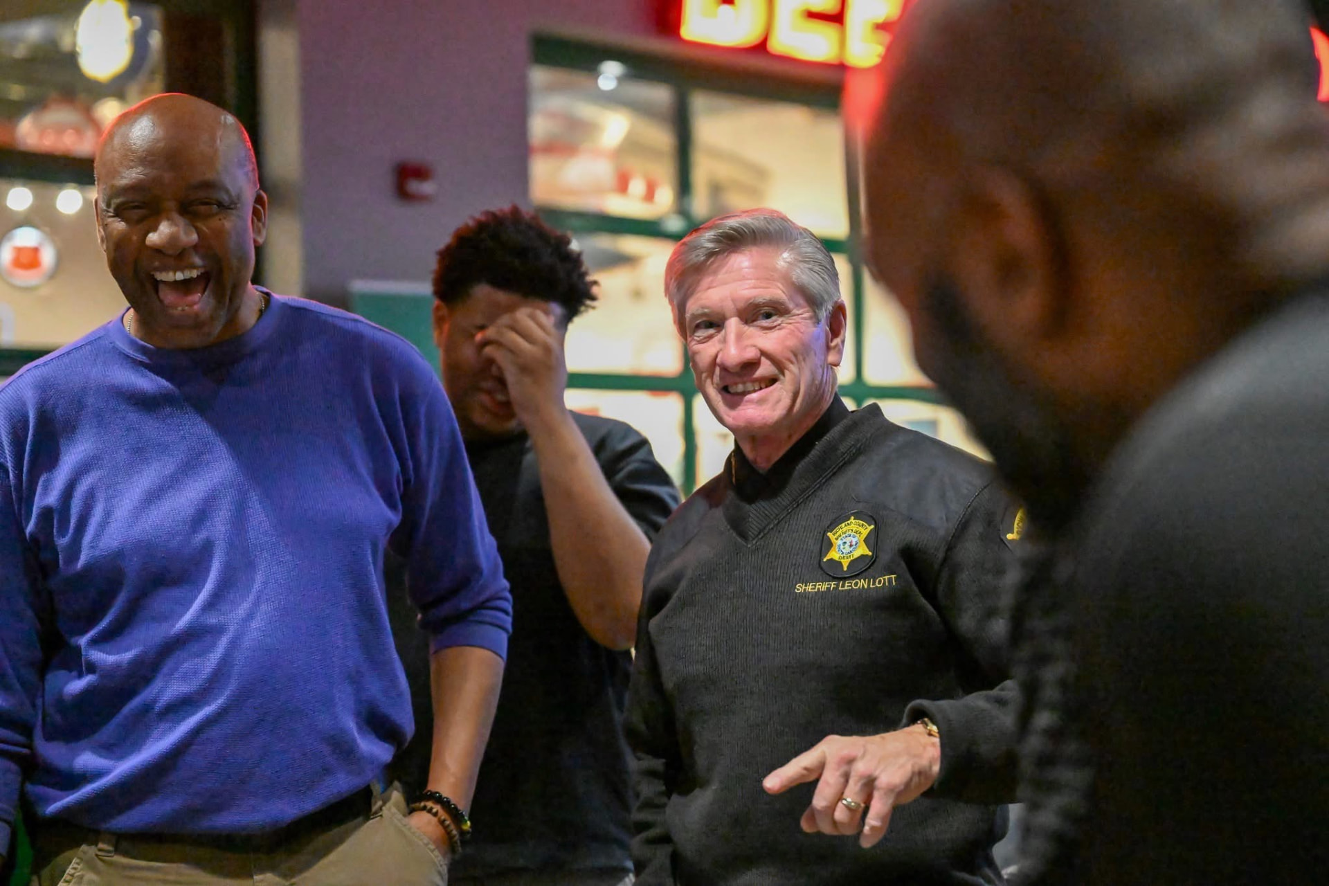 Men Matter members laughing with Sheriff Leon Lott at a fellowship gathering
