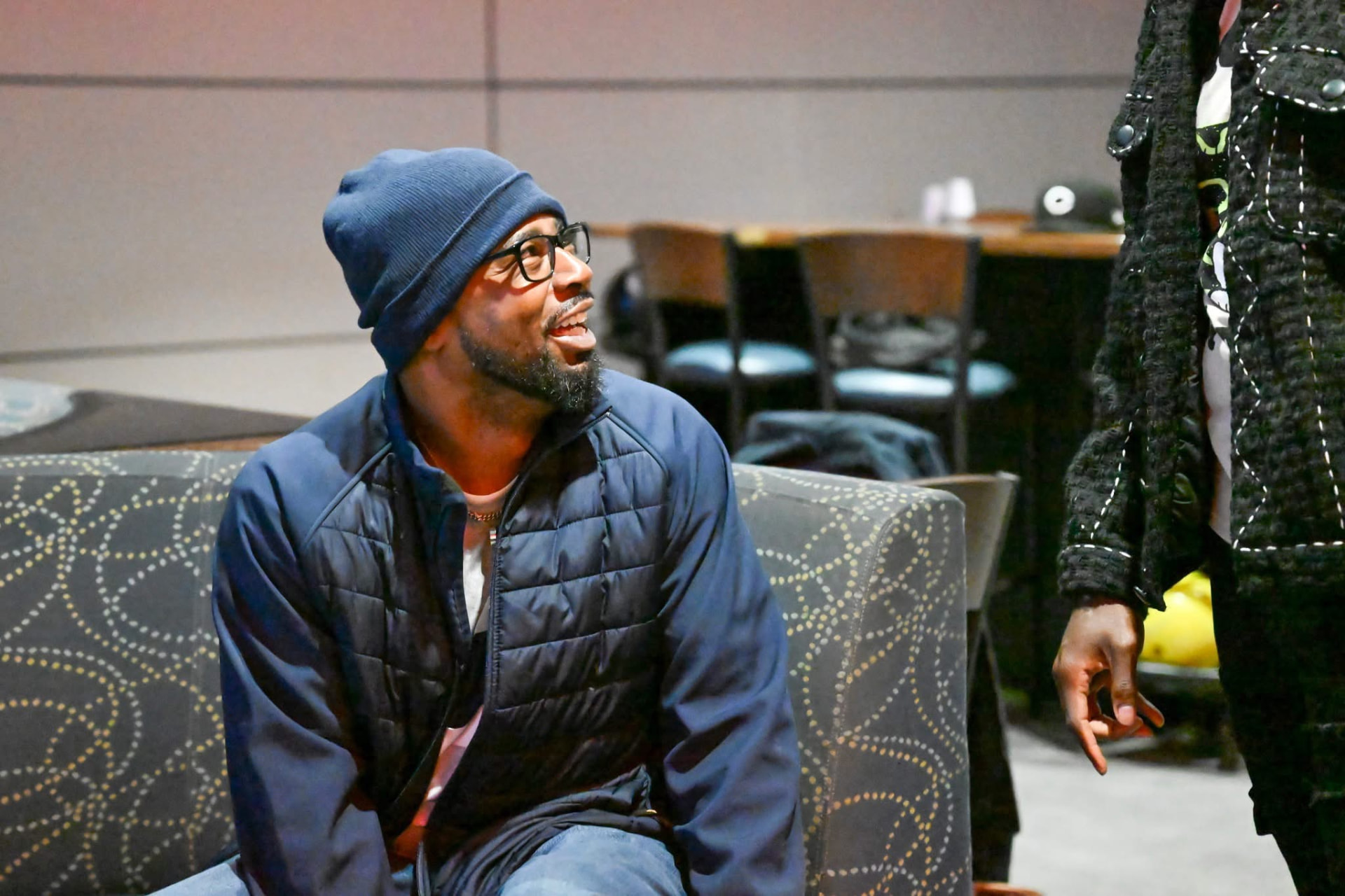 A Men Matter brother seated and smiling during a conversation at a gathering