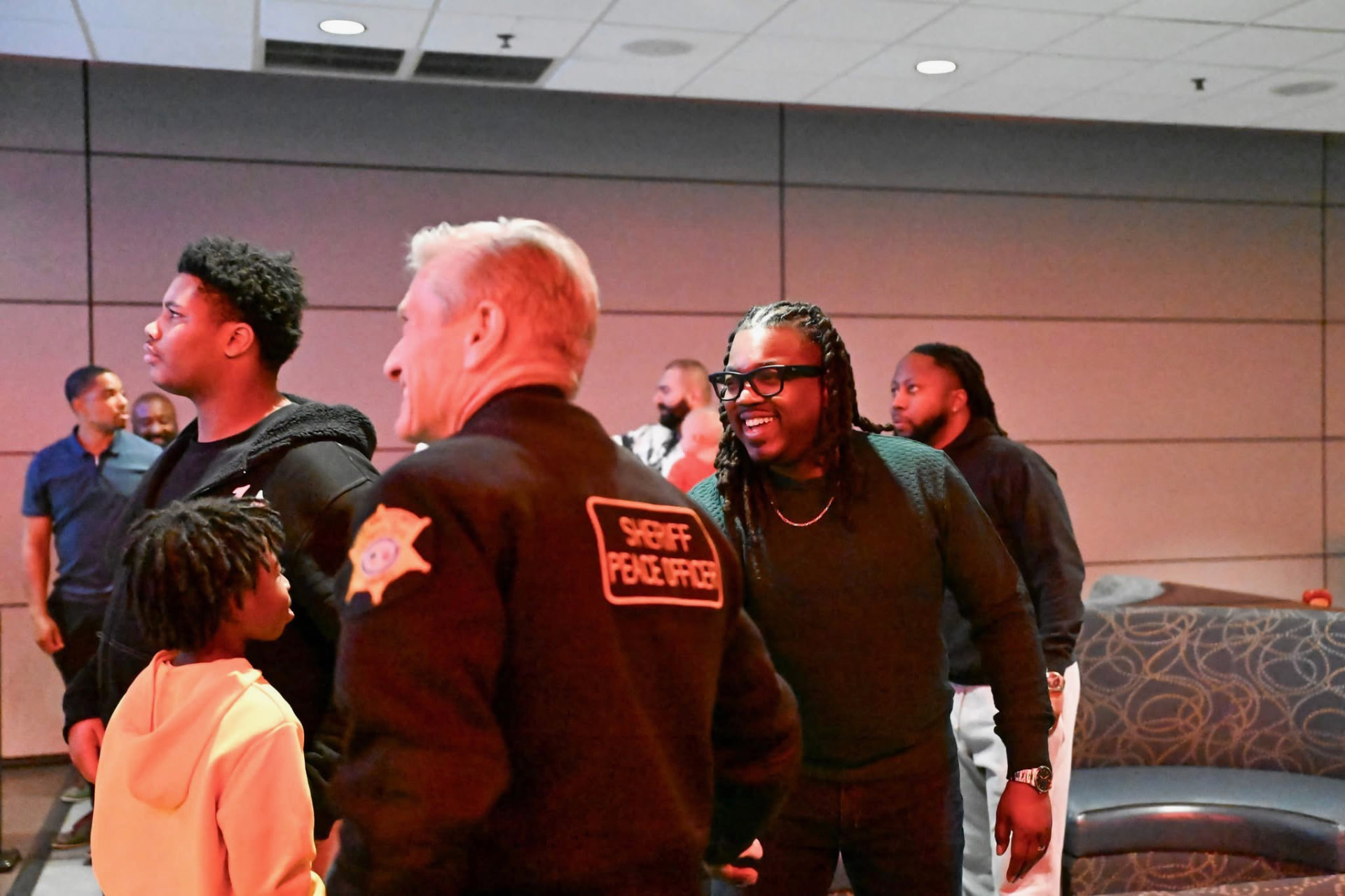 Men Matter brothers and family talking with a Richland County sheriff's deputy at a community gathering